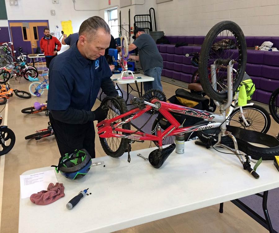 Don working on bike at a Repair Clinic.