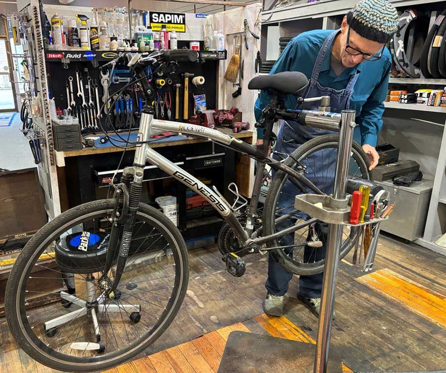 Don working on a bike in the shop.